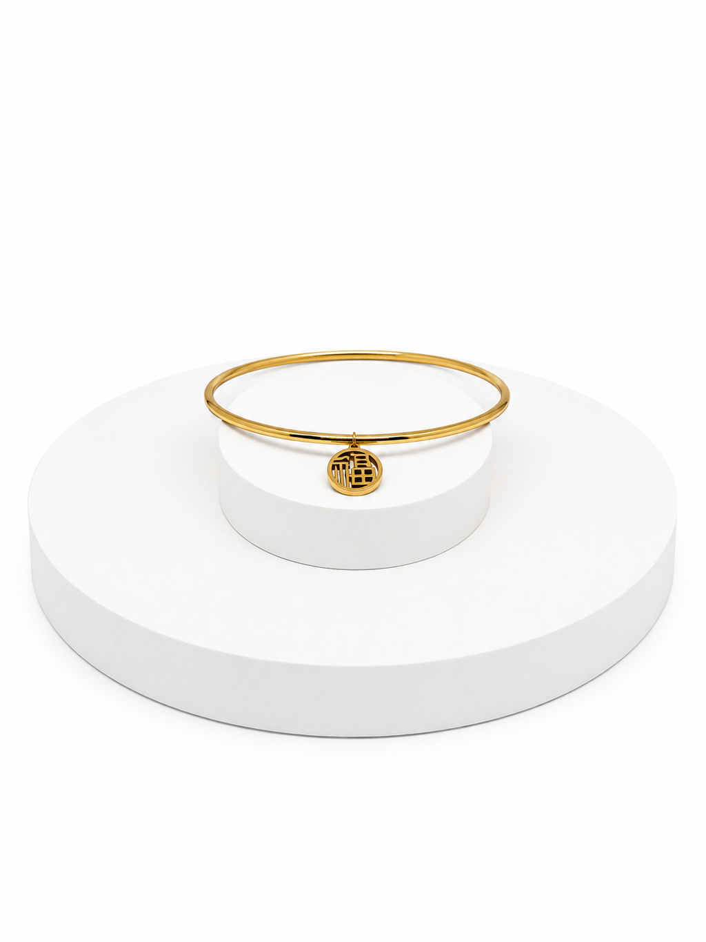 Gold bracelet on a white stand with a white background