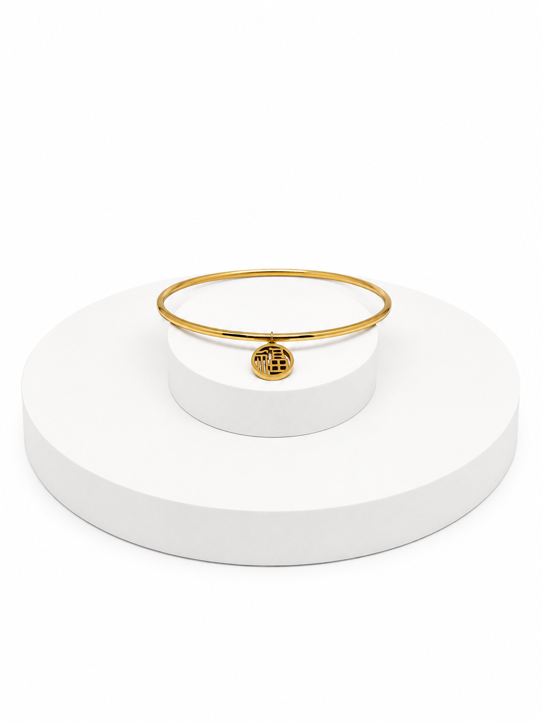 Gold bracelet on a white stand with a white background