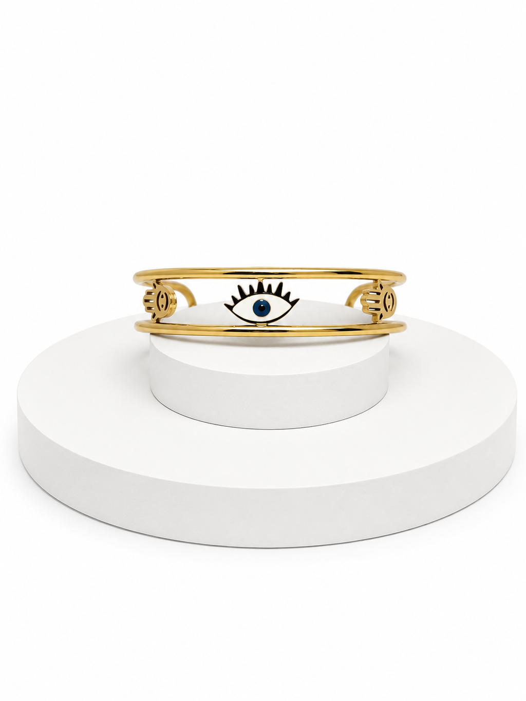 Gold bracelet with a blue gemstone on a white stand