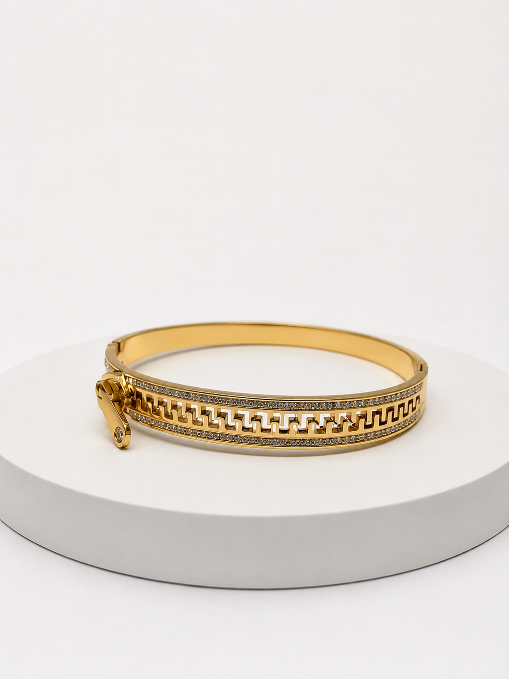 Gold bracelet with chain detail on a white background
